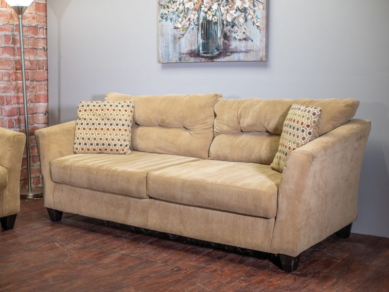 Sandy brown couch with decorative pillows