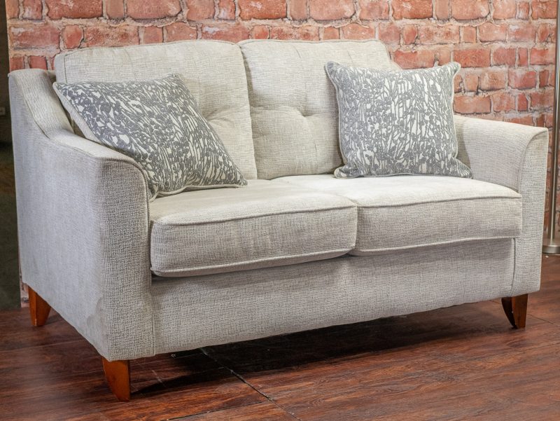 Gray loveseat with marbled pillows