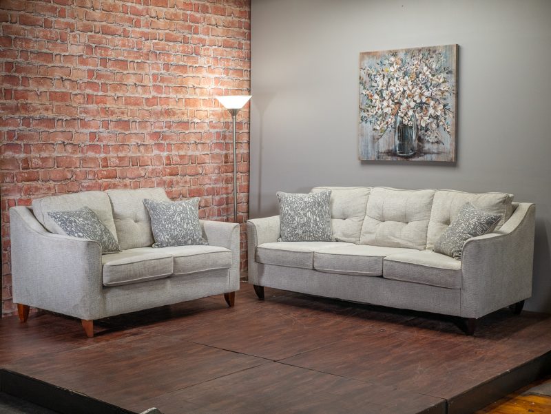 Gray couch and loveseat next to each other