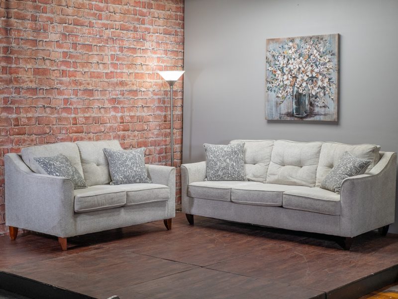 Gray couch and loveseat next to each other